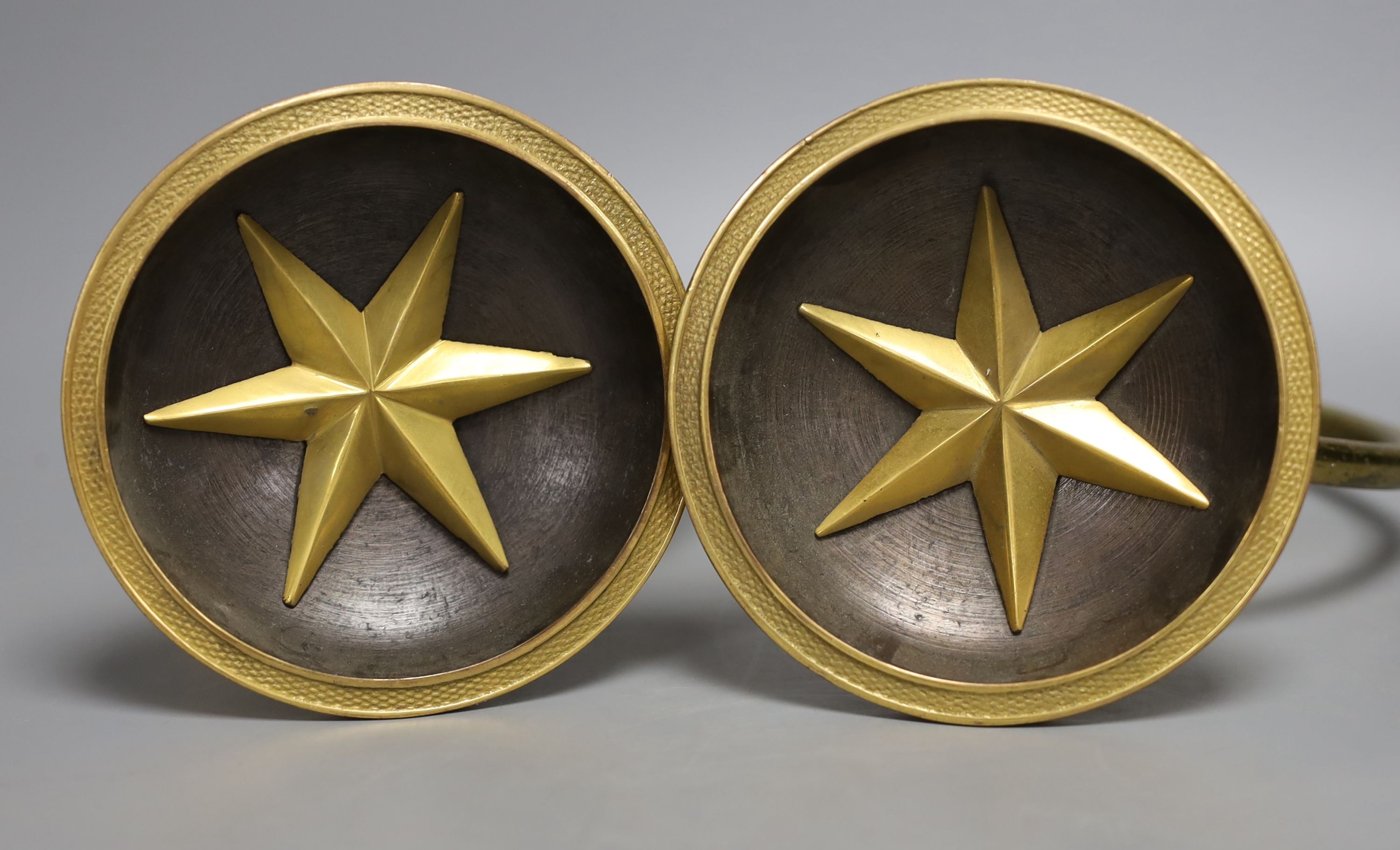 A pair of gilt metal curtain tie-backs and two other similar tiebacks